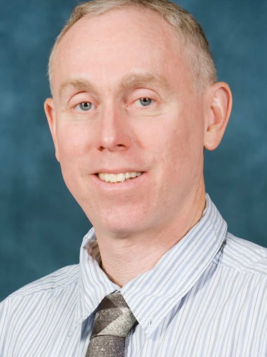 Man in stripy shirt and tie