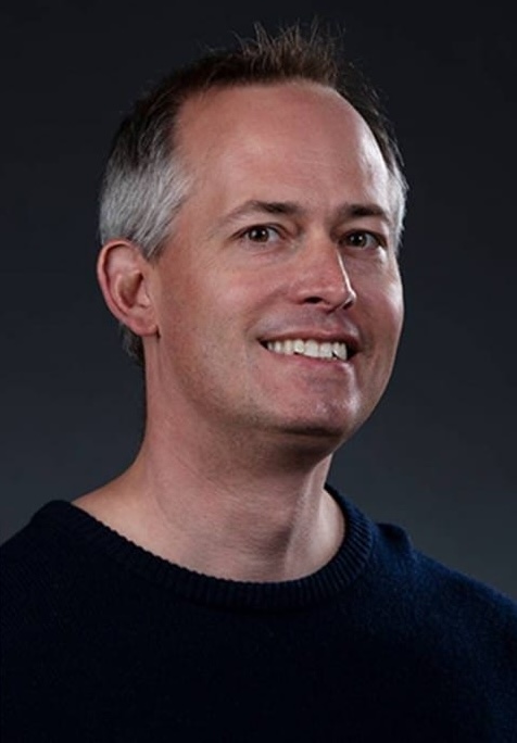 Man in black shirt smiling