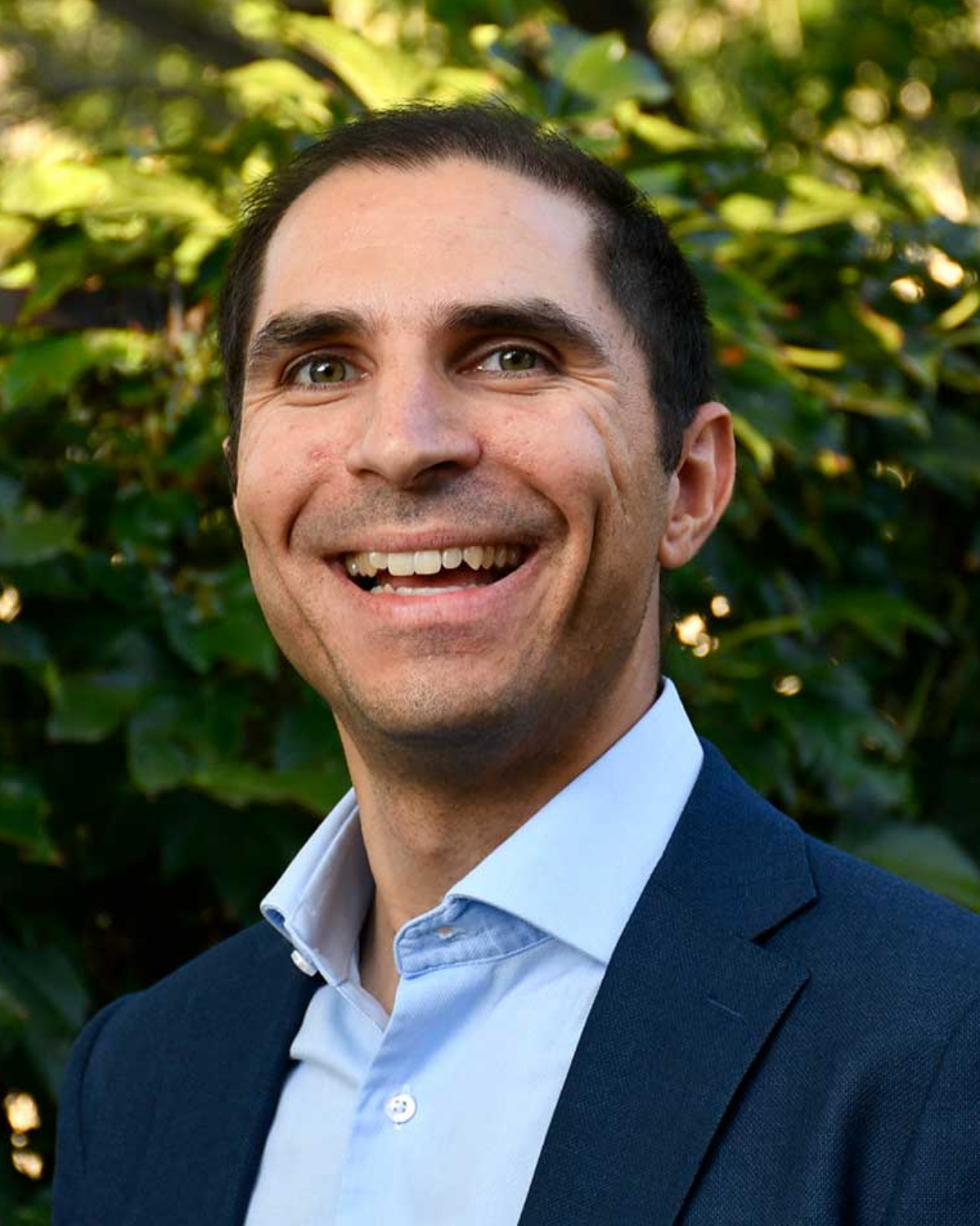 Man in dark suite smiling