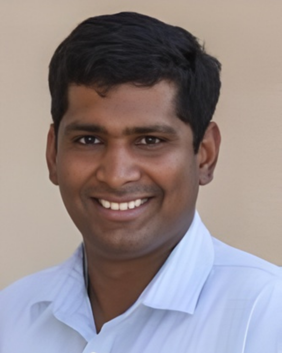 Man in light blue shirt smiling