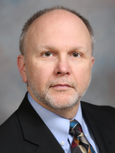 Portrait of a man in dark suit