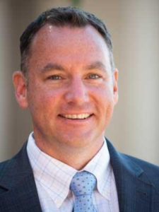 Man in a suit and tie smiling