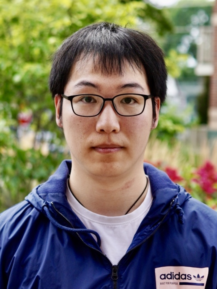 Men with short dark hair wearing glasses and a dark blue hoodie