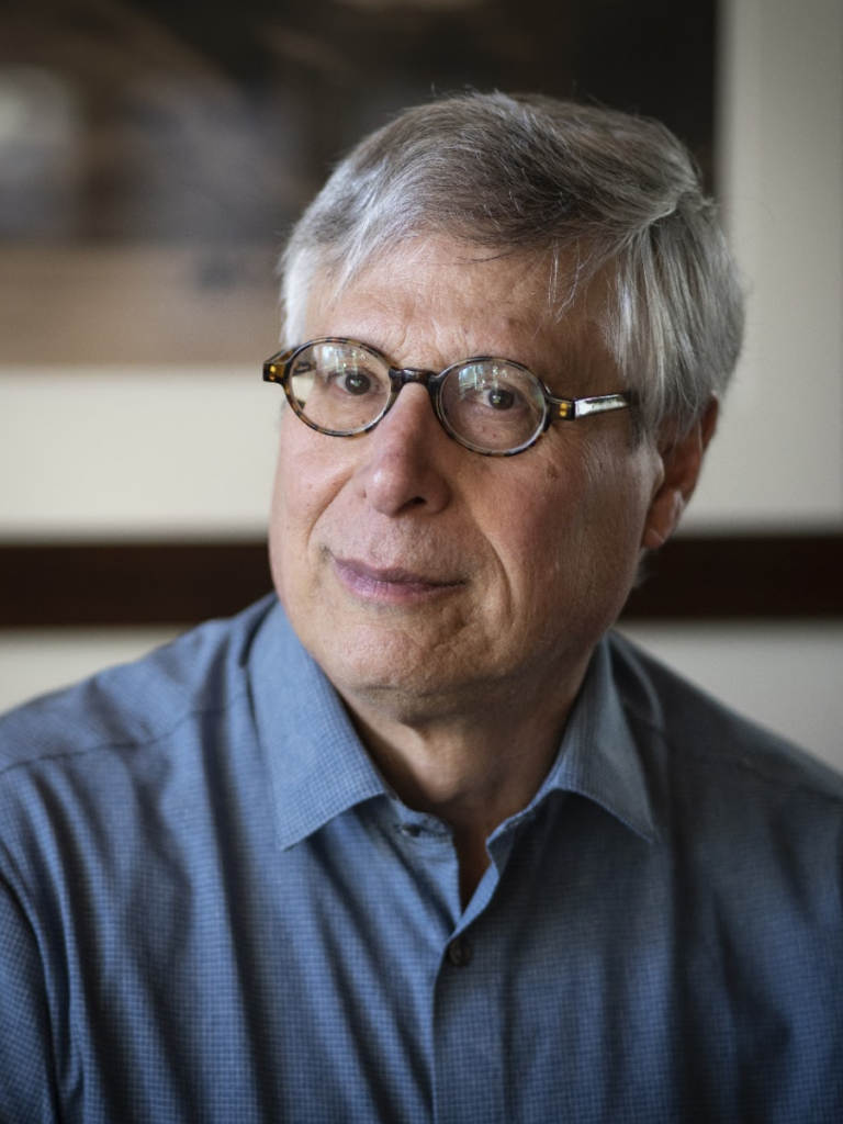 Man in blue shirt wearing glasses