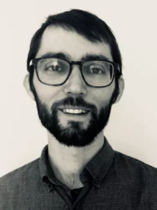 Bearded man wearing glasses and a dark shirt