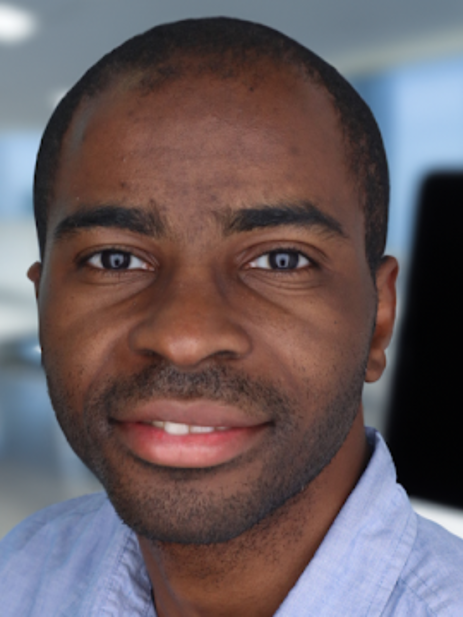 Man wearing a light blue shirt smiling